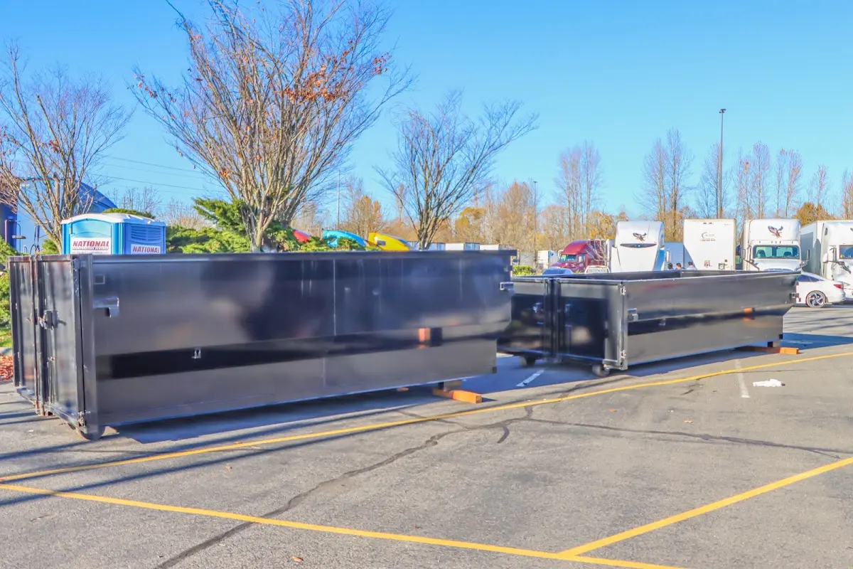 Professional dumpster rental service with roll-off container on residential driveway in Fairwood